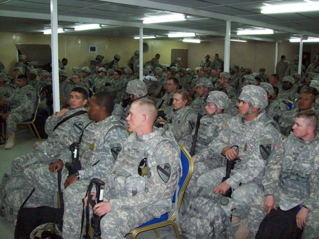 Soldiers from 2nd Brigade Combat Team, 1st Cavalry Division, sit through a briefing after arriving at Forward Operating Base Warrior, Kuwait, Iraq, Jan. 25. The Soldiers will be working with the local population to provide a more-stable...