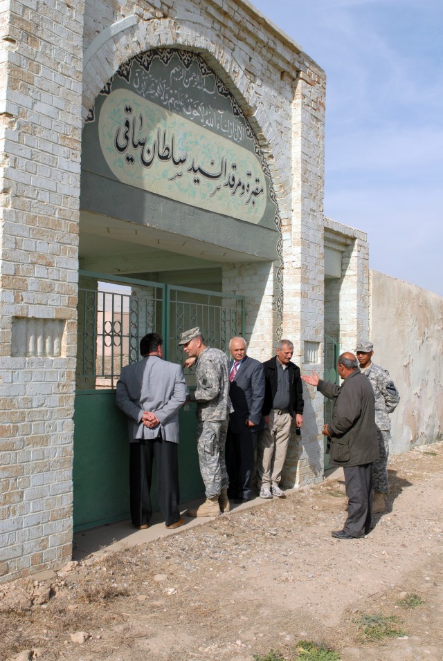 Officials from Bilawah and Tis'Ayn villages and officials from Forward Operating Base Warrior in Kirkuk, Iraq, stand outside the gate to Sultan Saqi Shrine also on FOB Warrior, Feb. 5. The leaders are discussing future plans for the shrine and how th...