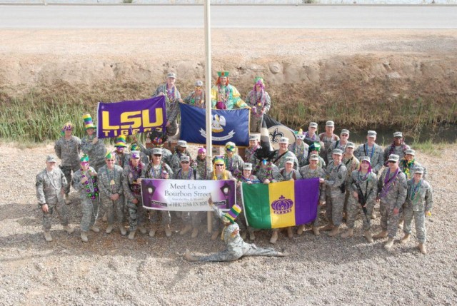 CAMP LIBERTY, Iraq - Members of the Louisiana National Guard's 225th Engineer Brigade pose in front of their headquarters Feb. 24. The Soldiers won't let a deployment to Iraq stand in their way to celebrate Mardi Gras.  Donations from home and a...