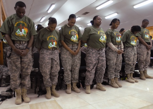 BAGHDAD – Multi-National Division – Baghdad Soldiers in the Warrior Chapel Choir pray during the invocation of the “African-American/Black History Month” Observance at Camp Liberty Feb. 22. The event highlighted the cultural advancements of all Ameri...