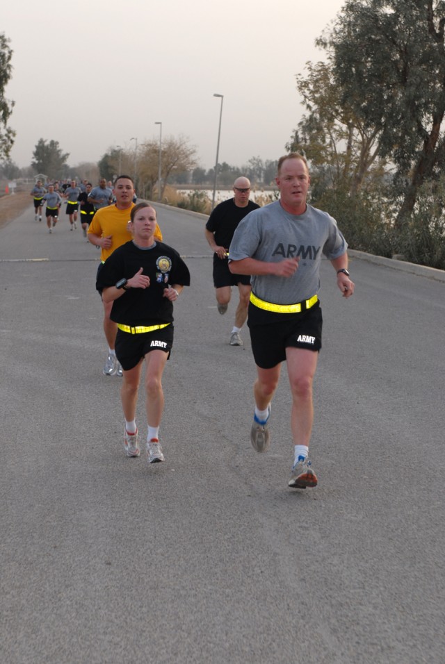BAGHDAD- 1st Lt. Andrea Bontrager (left) of the 299th Brigade Support Battalion, finishes first in the female-division, dashes the last mile of the race with a partner Feb. 21.   The Fort Riley, Kas. native finished the 5-kilometer course around Camp...
