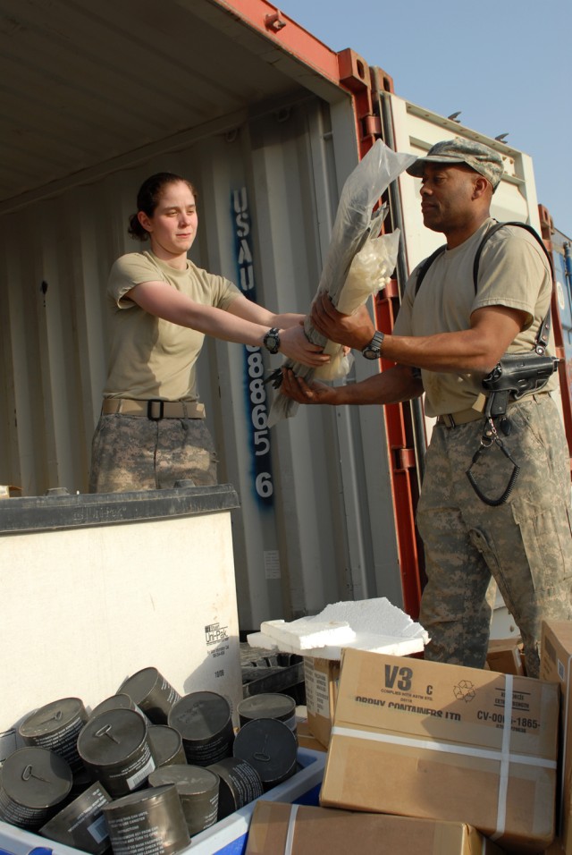 CAMP LIBERTY, Iraq - Spc. Nicole Delia, of Clifton Park, N.Y., and Sgt. Harold Carmen, of Plainfield, N.J., both assigned to the 340th Military Police Company, prepare space inside a storage facility Feb. 17 for equipment that recently arrived...