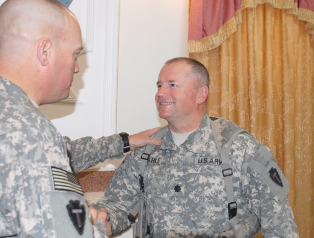 BAGHDAD - Col. Lee Henry (left), commander of Task Force Arrowhead, 56th Infantry Brigade Combat Team, 36th Infantry Division, Multi-National Division-Baghdad, congratulates newly promoted Lt. Col. Dean Dahle following a promotion ceremony at Camp...
