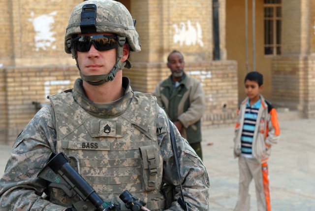 BAGHDAD - Staff Sgt. Bryan Bass, a mortar man assigned to 5th Squadron, 73rd Cavalry Regiment, 3rd Brigade Combat Team, 82nd Airborne Division, provides security while visiting a local school in the Rusafa district of eastern Baghdad, Feb. 25. Bass i...