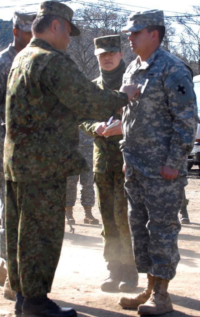 Japanese CSM Promotes Soldier to NCO Ranks