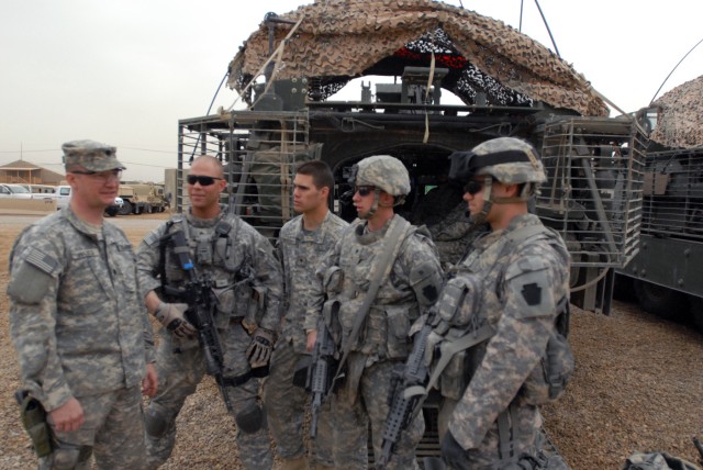 CAMP TAJI, Iraq-Lt. Col. Sam Hayes (left), of Newport, Pa., commander of 2nd Battalion, 112th Infantry Regiment, 56th Stryker Brigade Combat Team, Pennsylvania National Guard, meets with Soldiers from his battalion as they prepare for a patrol...
