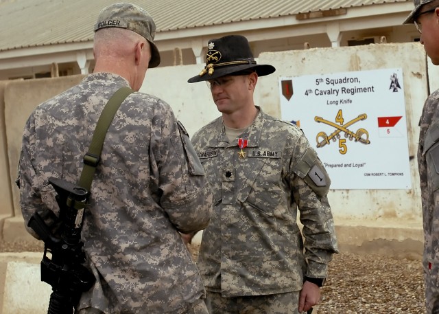 BAGHDAD - Lt. Col. John Richardson IV (right), commander, 5th Squadron, 4th Cavalry Regiment, 2nd Heavy Brigade Combat Team, 1st Infantry Division, Multi-National Division-Baghdad is presented with the Bronze Star with 'V' device for valor by Maj....