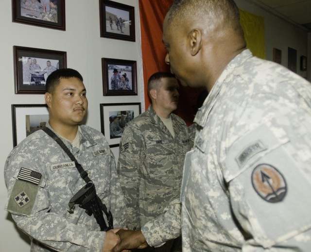 Lt. Gen. Lloyd Austin III, the commander of Multi-National Corps - Iraq, presents a commendation coin to Pfc. Brandon Quintanilla, a mechanic in the 2nd Battalion, 12th Cavalry Regiment, 4th Brigade Combat Team, 1st Cavalry Division, at the Long...