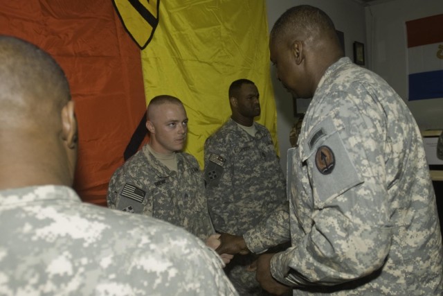 Lt. Gen. Lloyd Austin III, the commander of Multi-National Corps - Iraq, presents a commendation coin to Sgt. Jason Duehr, a vehicle recovery specialist in the 27th Brigade Support Battalion, 4th Brigade Combat Team, 1st Cavalry Division, at the...