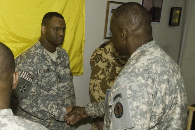 Lt. Gen. Lloyd Austin III, the commander of Multi-National Corps - Iraq, presents a commendation coin to Sgt. 1st Class Jye Green, a battle captain who maintains communication with higher and lower echelon headquarters for 4th Brigade Combat Team,...