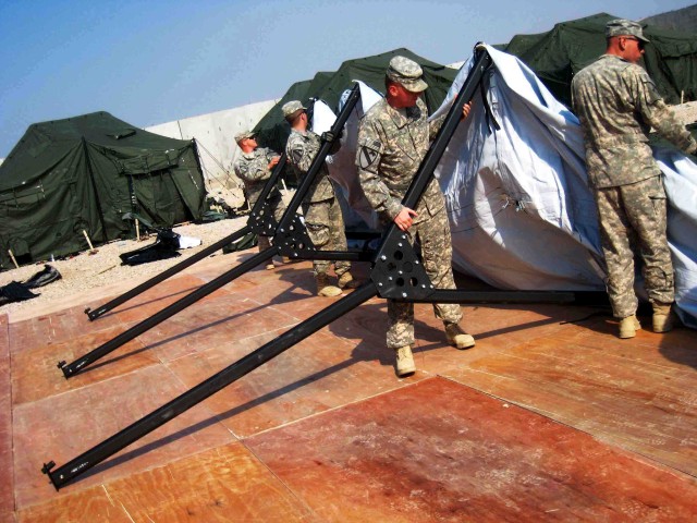Soldiers of the 5th Battalion, 82nd Field Artillery Regiment, 4th Brigade Combat Team, 1st Cavalry Division, ‘Black Dragons’ set-up tents in the living areas at Forward Operating Base Hunter, Iraq. The incoming Black Dragon troops are...