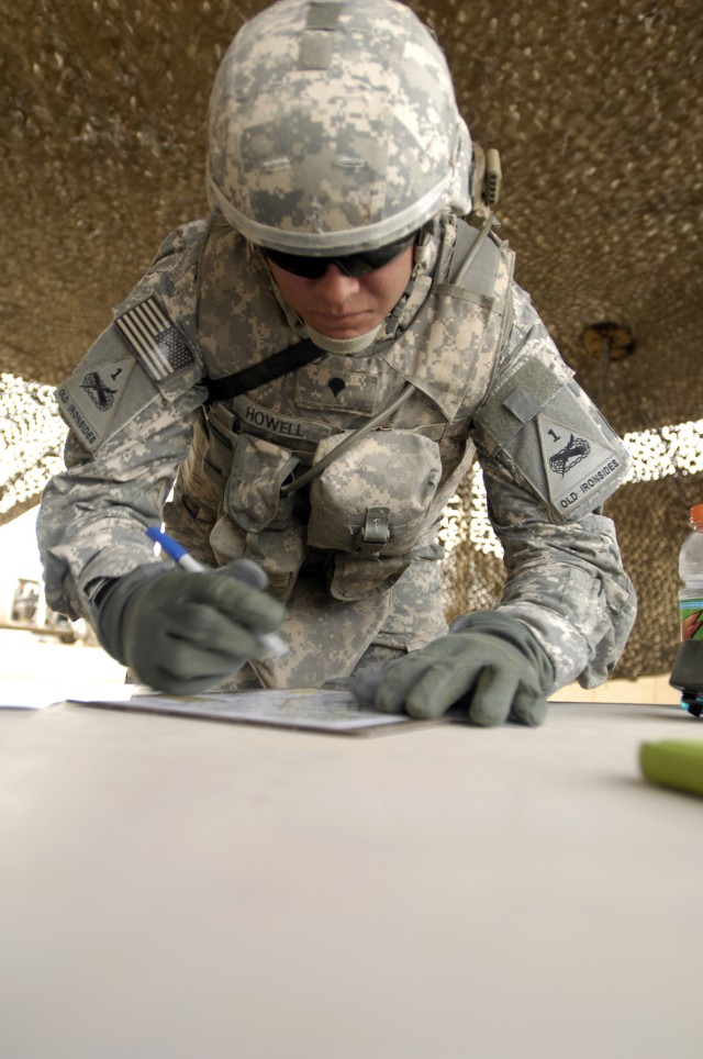 BAGHDAD - Spc. Henry Howell, 4th Battalion, 27th Field Artillery Regiment, 2nd Brigade Combat Team, 1st Armored Division, Multi National Division-Baghdad, makes notes on a map during a Warrior Task event at the "Iron Brigade's" Soldier of the Year co...