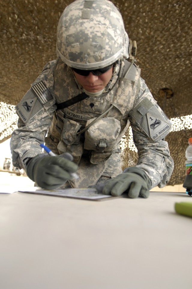 BAGHDAD - Spc. Henry Howell, 4th Battalion, 27th Field Artillery Regiment, 2nd Brigade Combat Team, 1st Armored Division, Multi National Division-Baghdad, makes notes on a map during a Warrior Task event at the "Iron Brigade's" Soldier of the Year...