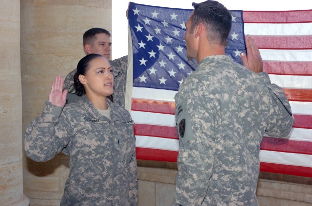 VICTORY BASE COMPLEX, Iraq- During a reenlistment ceremony at al-Faw Palace, Oxnard, Calif. native Chief Warrant Officer 2 Chastity Beckham (left), an imagery technician with the Division Special Troops Battalion, 1st Cavalry Division,...