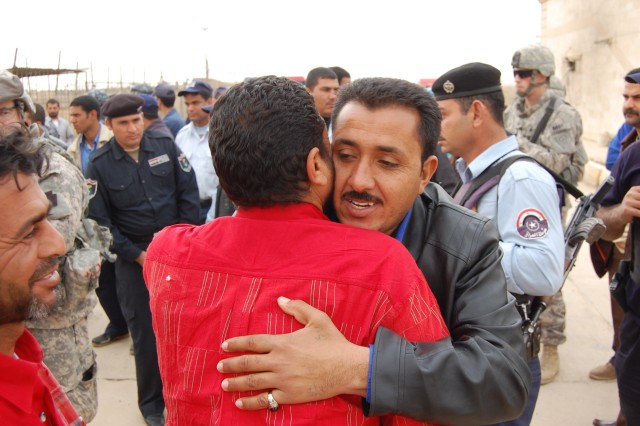 ISTAQLAL, Iraq - A released detainee hugs his family member during a release ceremony March 1at the Boob Al Sham police station in the Istaqlal district of Baghdad. Twelve former detainees were released from a Coalition Forces compound to the custody...