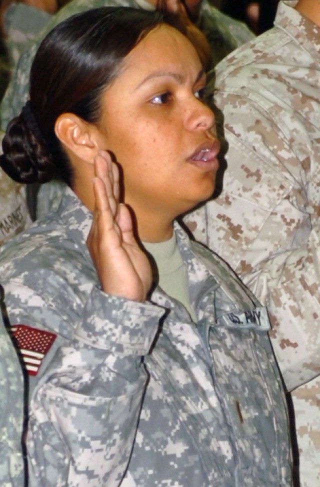 VICTORY BASE COMPLEX, Iraq - Taking the last major step of naturalization, 2nd Lt. Memorina Edwin Barnes, executive officer, Headquarters Service Company, Division Special Troops Battalion, 1st Cavalry Division, Multi-National Division-Baghdad...