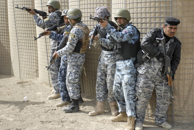 Iraqi Policemen, from the Muthana Tactical Security Unit in southern Iraq, practice room clearing procedures taught by the 2nd Battalion, 12 Cavalry Regiment, 4th Brigade Combat Team, 1st Cavalry Division, near Contingency Operating Base Adder, Iraq,...