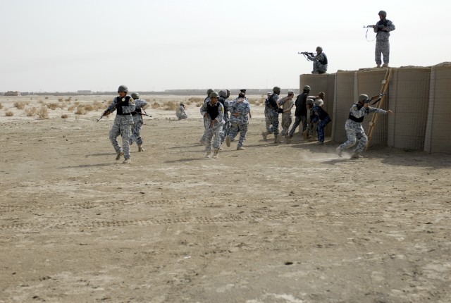 Iraqi Policemen, from the Muthana Tactical Security Unit in southern Iraq, practice detainees operations during a room clearing exercise taught by the 2nd Battalion, 12 Cavalry Regiment, 4th Brigade Combat Team, 1st Cavalry Division, near Contingency...