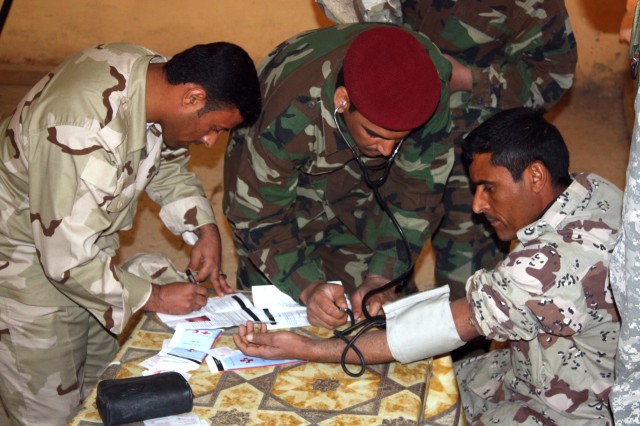 Troops from the 10th Motorized Transportation Unit, 10th Division Iraqi Army check one of their fellow Soldiers for high blood pressure during a health fair at Camp Whitehorse near Contingency Operating Base Adder, Iraq, Feb. 28. The Iraqi led traini...