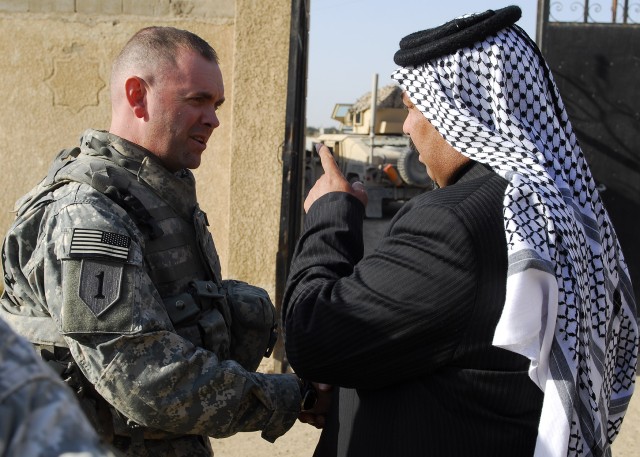 MAHMUDIYAH, Iraq - Lt. Col. Jim Bradford, 1st Combined Arms Battalion, 63rd Armor Regiment, Multi-National Division- Baghdad, of Lynchburg, Tenn., shakes hands with Sheik Hassan after a meeting with local Mahmudiyah sheiks in Mahmudiyah Feb. 25. Duri...