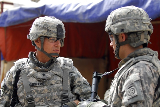 BAGHDAD - Brig. Gen. Frederick S. Rudesheim, deputy commanding general for support, 1st Cavalry Division and Multi National Division- Baghdad, speaks with Capt. Michael Thompson, of Vienna, Va. commander, Company C, 1st Battalion, 505th, Parachute...