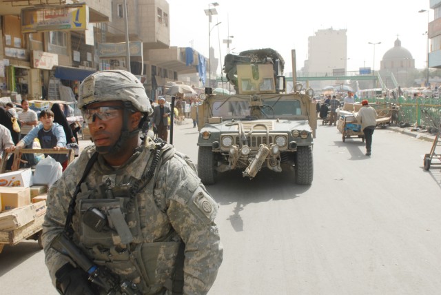 BAGHDAD - A native of Miami, Staff Sgt. Daniel Dixon assigned to Troop B, 5th Squadron, 73rd Cavalry Regiment, 3rd Brigade Combat Team, 82nd Airborne Division, clears the way for his humvee to follow through a busy open-air Shorja Market in...