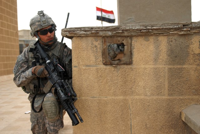 BAGHDAD - On the roof of an Iraqi Army building Feb. 27 in Central Baghdad, Sgt. Jeffery Ellis, a team leader assigned to Troop B, 5th Squadron, 73rd Cavalry Regiment, 3rd Brigade Combat Team, 82nd Airborne Division, peeks his head around a ledge...