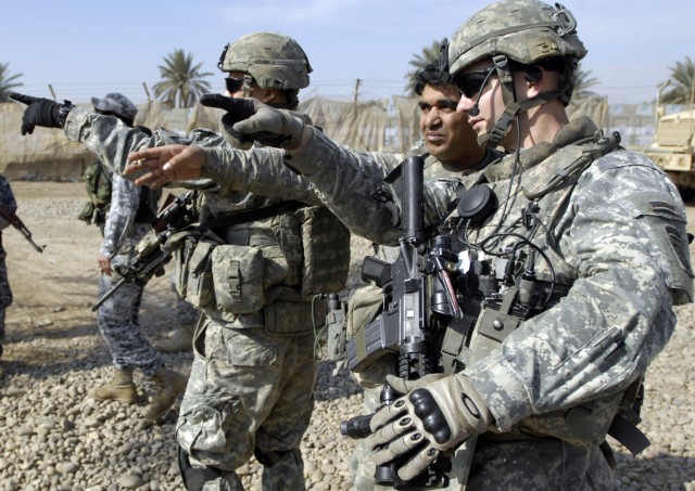 BAGHDAD - Russia, Ohio native 1st Lt. Chris Timmerman (right), 1st Battalion, 505th Parachute Infantry Regiment, 3rd Brigade Combat Team, 82nd Airborne Division, identifies a building in the distance with the assistance of his translator....