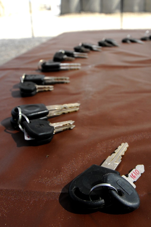 BAGHDAD- Keys to 14 ArmaTrac 602 tractors lie on a table before being presented to local Sheiks in the Lutifiyah Nahia by Task Force 4th Battalion, 27th Field Artillery, 2nd Brigade Combat Team, 1st Armored Division, Multi-National...