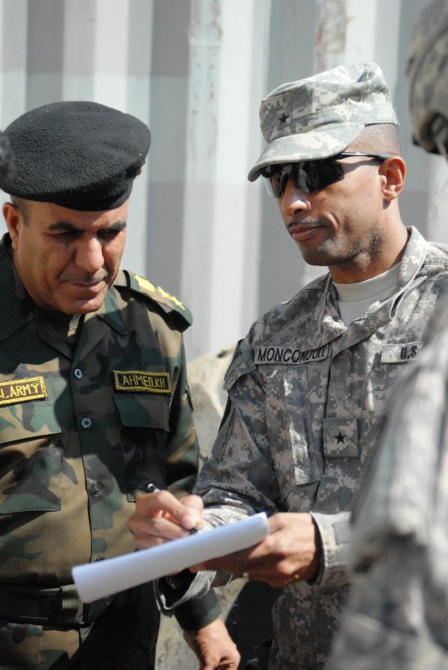 An engineering partnership translates on paper as Brig. Gen. Owen Monconduit (right), commander, 225th Engineer Brigade, 1st Cavalry Division, Multi-National Division-Baghdad, explains to the 6th Iraqi Army Engineer Regiment Commander, Col. Ahmed Sad...