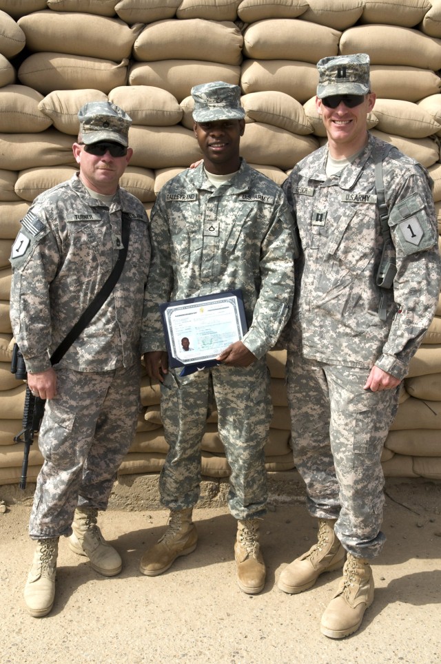 BAGHDAD - Sgt. 1st Class Kevin Turner (left), Pfc. Richerson Talleyrand (center) and Capt. Mark Guelich, Headquarters and Headquarters Company, 1st Battalion, 7th Field Artillery Regiment, 2nd Heavy Brigade Combat Team, 1st Infantry Division, pose af...
