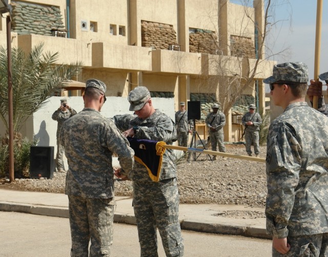 BAGHDAD-  Lt. Col. Matthew Elledge (center), commander,  1st Battalion, 22nd Infantry Regiment, 1st BCT, 4th Inf. Div.,  and Command Sgt. Maj. Timothy Guden (left) case the battalion’s colors during a transfer of authority ceremony at Forward...