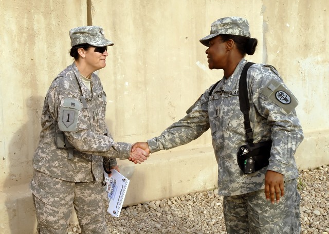 BAGHDAD - Command Sgt. Maj. Althea Dixon (right), senior enlisted advisor to the Army Surgeon General, U.S. Army Medical Command, shakes hands with Command Sgt. Maj. Julia Kelly, senior enlisted leader, 299th Brigade Support "Lifeline" Battalion, at ...