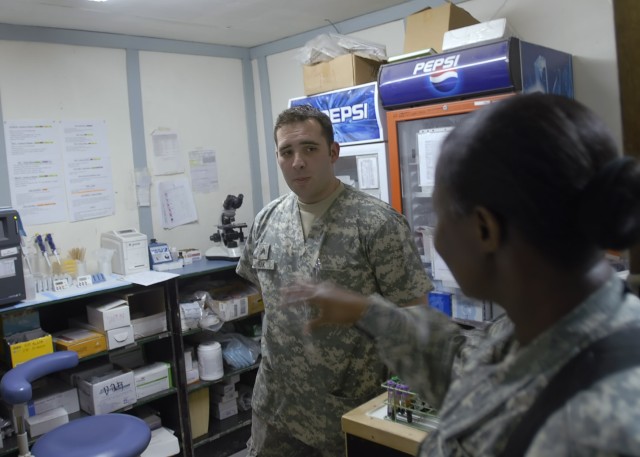 BAGHDAD - Command Sgt. Maj. Althea Dixon (right), senior enlisted advisor to the Army Surgeon General, U.S. Army Medical Command, speaks with Allentown, Pa. native, Sgt. Adam Funk, a lab technician serving with Company C, 299th Brigade Support "Lifel...