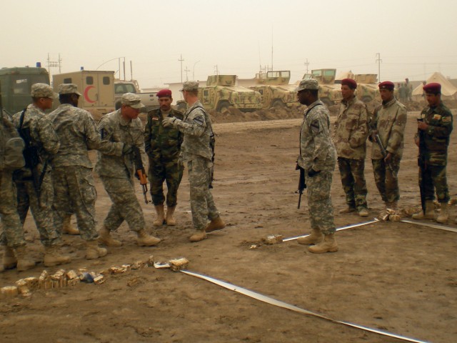 U.S. Soldiers, assigned to the 5th Battalion, 82nd Field Artillery Regiment, 4th Brigade Combat Team, 1st Cavalry Division, demonstrate how to properly clear a room during a joint training event with troops from the 3rd Battalion, 41st Iraqi Army...