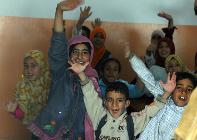 BAGHDAD - Jubilant Iraqi students fill the hallways during the grand re-opening of Almuwifikia School sponsored by the 1st Combined Arms Battalion, 63rd Armor Regiment in Lutifiyah, Mahmudiyah Qada March 3. The two-month $127,000 refurbishment was pa...