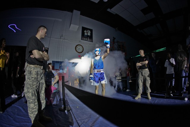 Smoke, lasers and pounding music set the tone as lightweight finalist, Pvt. Joshua Stewart of Orlando, Fla., 1st Brigade, 1st Armored Division, Fort Bliss, Texas, enters the fighting floor during the III Corps, first-ever Boxing Smoker finals, held a...