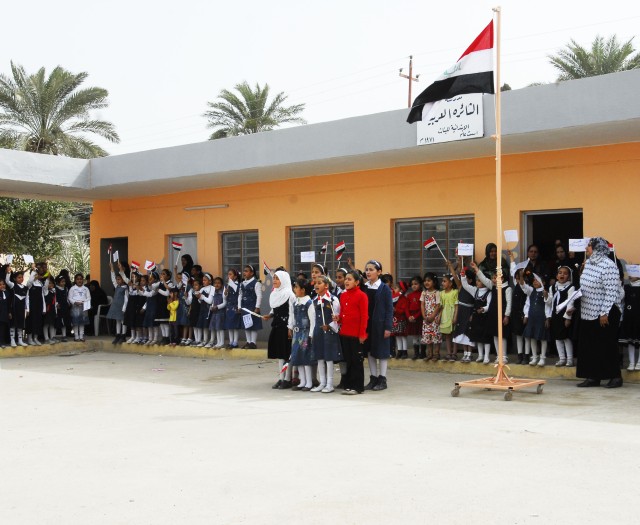 Students cheer during a ceremony as the Nahia Qada council, Ministry of Education, and school teachers oversee the re-opening of Althaira School in Mahmudiyah, March 8. The school has been remodeled by contractors which included increasing...