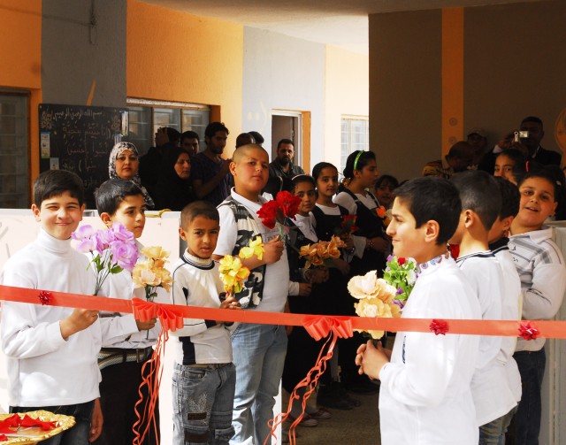 Students in Althaira await the ribbon cutting ceremony to celebrate the re-opening of their school March 8. The school was built in 1971 and has the largest student enrollment in Althaira, Mahmudiyah Qada. Local construction contractors remodeled...