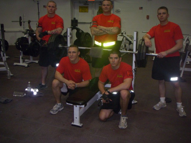 Soldiers from the 5th Battalion, 82nd Field Artillery Regiment, 4th Brigade Combat Team, 1st Cavalry Division 'Black Dragon Battalion,' Display their unit pride by sporting their vibrant red physical training t-shirts at Forward Operating Base...