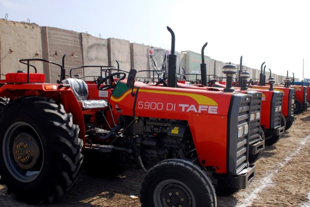 BAGHDAD-Twenty TAFE 5900 tractors stand ready for work with the Radwaniyah Farmer's Association March 6.  Funded through a Multi-National Division-Baghdad program, local farmers will be able to rent the tractors from the Farmer's Association in...