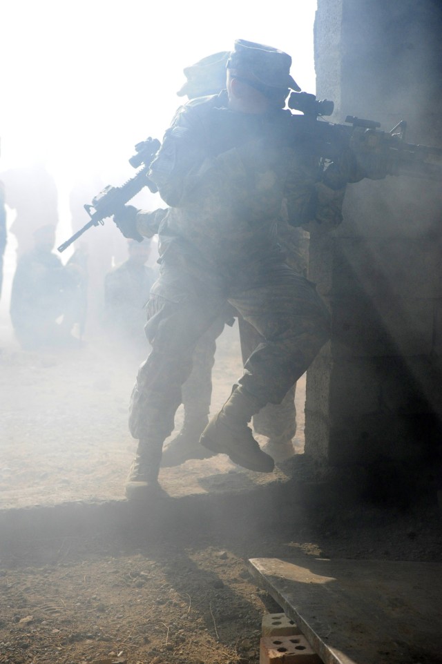 Master Sgt. Robert Eplee, a native of Brevard, N.C., and a member of Military Training and Transition Team 47693, and other team members put on a building clearing demonstration during Military Operations Urban Terrain Training, March 2, in the...