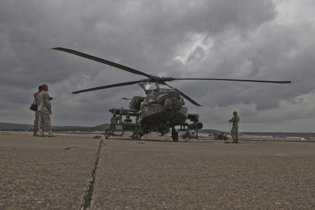 Soldiers of 1st Attack Reconnaissance Battalion, 227th Aviation Regiment, 1st Air Cavalry Brigade, 1st Cavalry Division, standby as Col. Douglas Gabram, from Cleveland, commander of the 1st ACB, straps III Corps Command Sergeant Major Neil Ciotola...