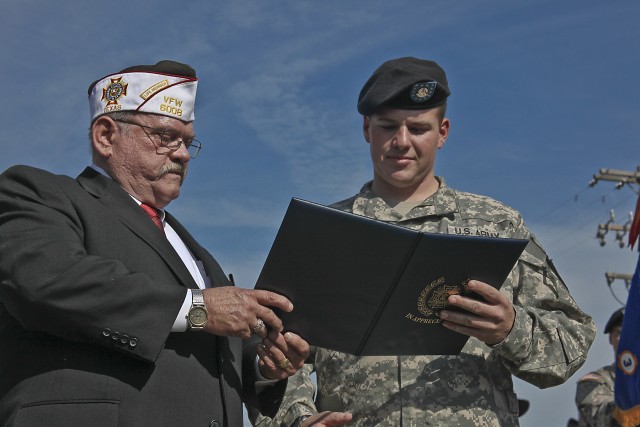 Specialist Ryan Frushour, of Denver, a UH-60 Black Hawk Helicopter crew chief in Company B, 3rd Assault Helicopter Battalion, 227th Aviation Regiment, 1st Air Cavalry Brigade, 1st Cavalry Division, received an award from Harry Munn, of Hewitt,...
