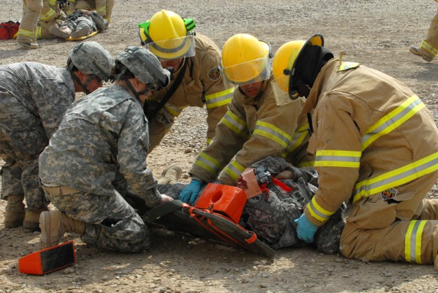 CAMP LIBERTY, Iraq -Sgt. Bridget Cruz-Bianchi (left foreground), from Bainbridge, Ga., and Spc. Kailey Good (left background), from Muncie, In., both combat medics attached to 299th Brigade Support Battalion, 1st Infantry Division, get a long...