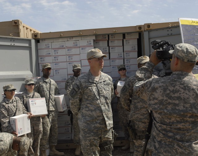 BAGHDAD - San Diego native Pfc. Jamie Mannion (right), 2nd Heavy Brigade Combat Team 'Dagger," 1st Infantry Division, Multi-National Division - Baghdad, films Dagger Soldiers, to include Dearborn, Mich. native Col. Joseph Martin, commander, 2nd...