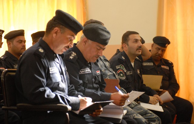 BAGHDAD - Mahmudiyah Iraqi Police take notes while listening to Iraqi judges from their district during a training meeting held to teach the IP investigative techniques and the criminal justice process in Mahmudiyah, March 12. The meeting was the fir...