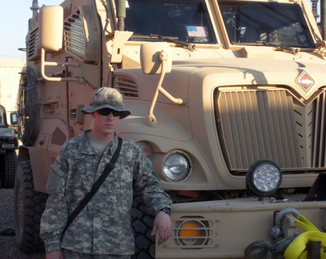 BAGHDAD-Louisville, Ky. native, Pfc. Brandon Coyle, Company E, 299th Brigade Support Battalion, currently part of the 1st Combined Arms Battalion, 63rd Armor Regiment, stands next to a Mine Resistant Ambush Protected vehicle, or MRAP, during his depl...