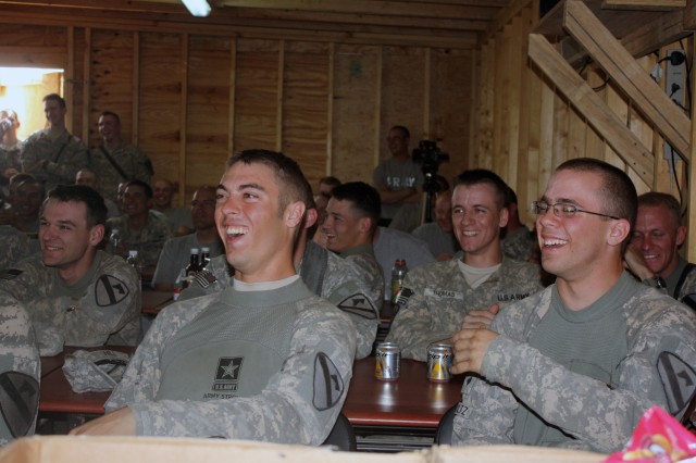 Soldiers from the 4th Brigade Combat Team, 1st Cavalry Division share a laugh during a comedic performance from the 'Comics Ready To Entertain' tour that visited the troops at Joint Security Station Apache, Iraq, March 8. This was the first...