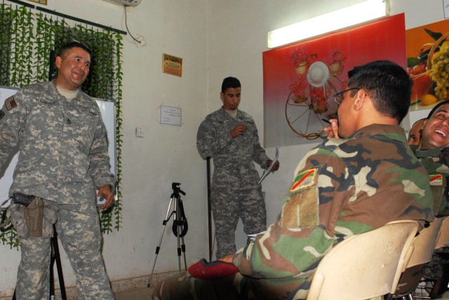 BAGHDAD - Soldiers of 6th Iraqi Army Division receive a lesson in basic English from Sgt. 1st Class Gabriel Ramirez, Team Weasel, 6th IA Div. Military Transition Team. The Soldiers are eager to learn, according to Ramirez. "These guys are here becaus...